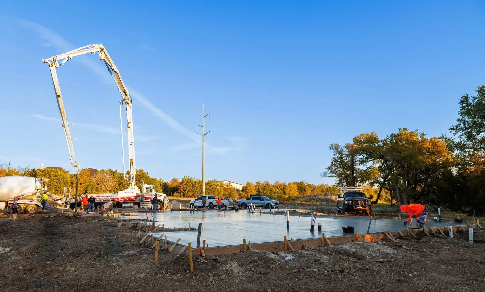 Wide view of a 120-yard residential foundation placement with the concrete pump and Western Star crew